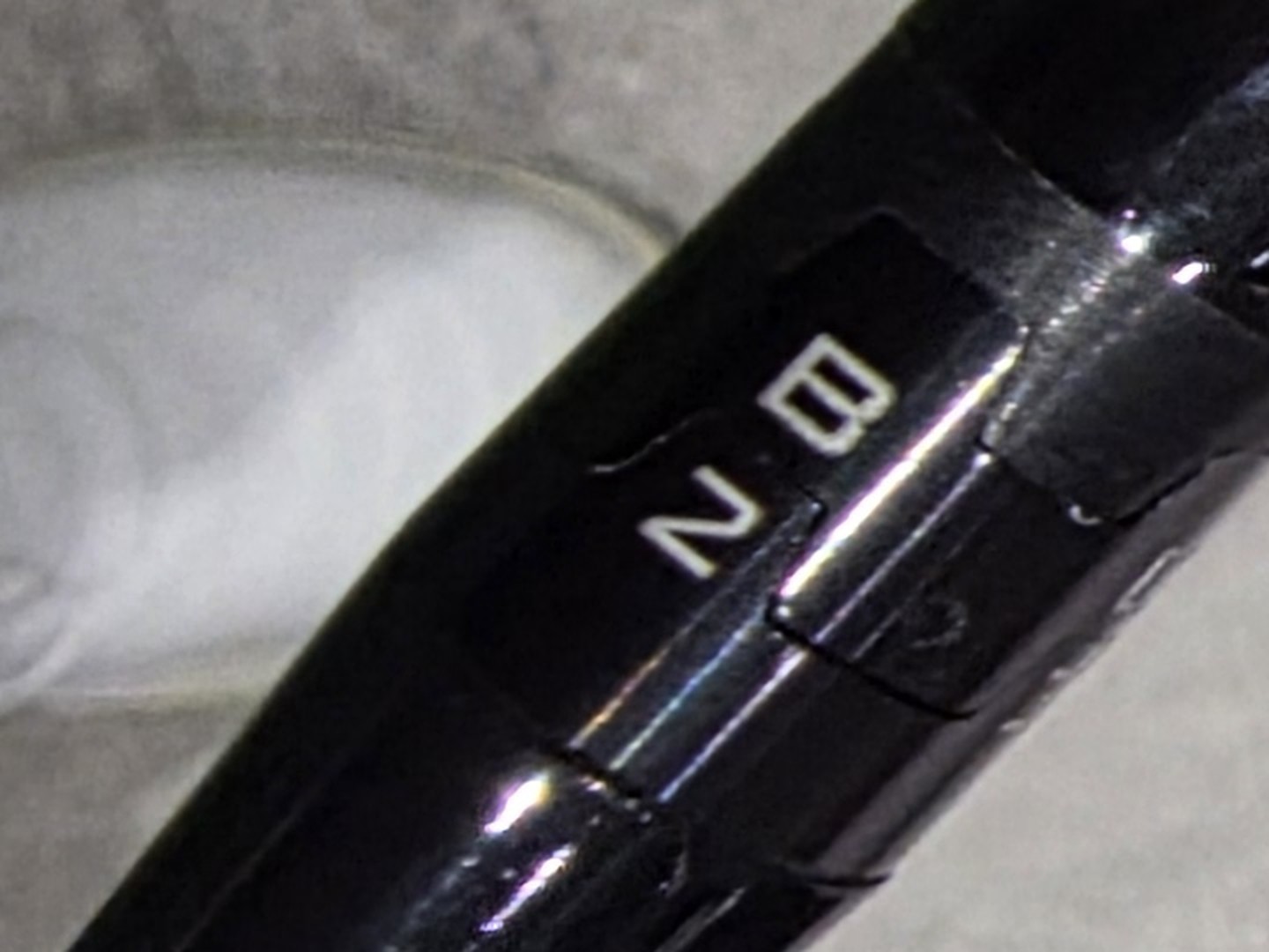 Close-up of the SureFit hosel sleeve on the author's Titleist TSR3 driver, stamped B and 2.