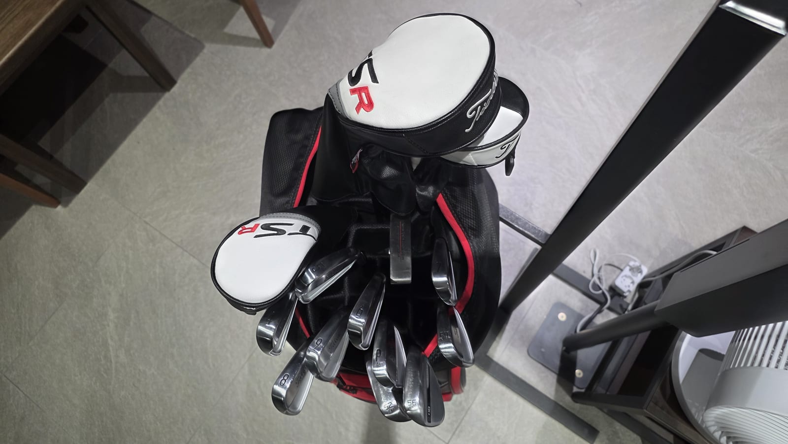 Looking down into the author's golf bag: three white Titleist TSR headcovers on top, Titleist T100 irons fanned out below, and the short clubs stamped P with 46, then 50, 52 and 56.