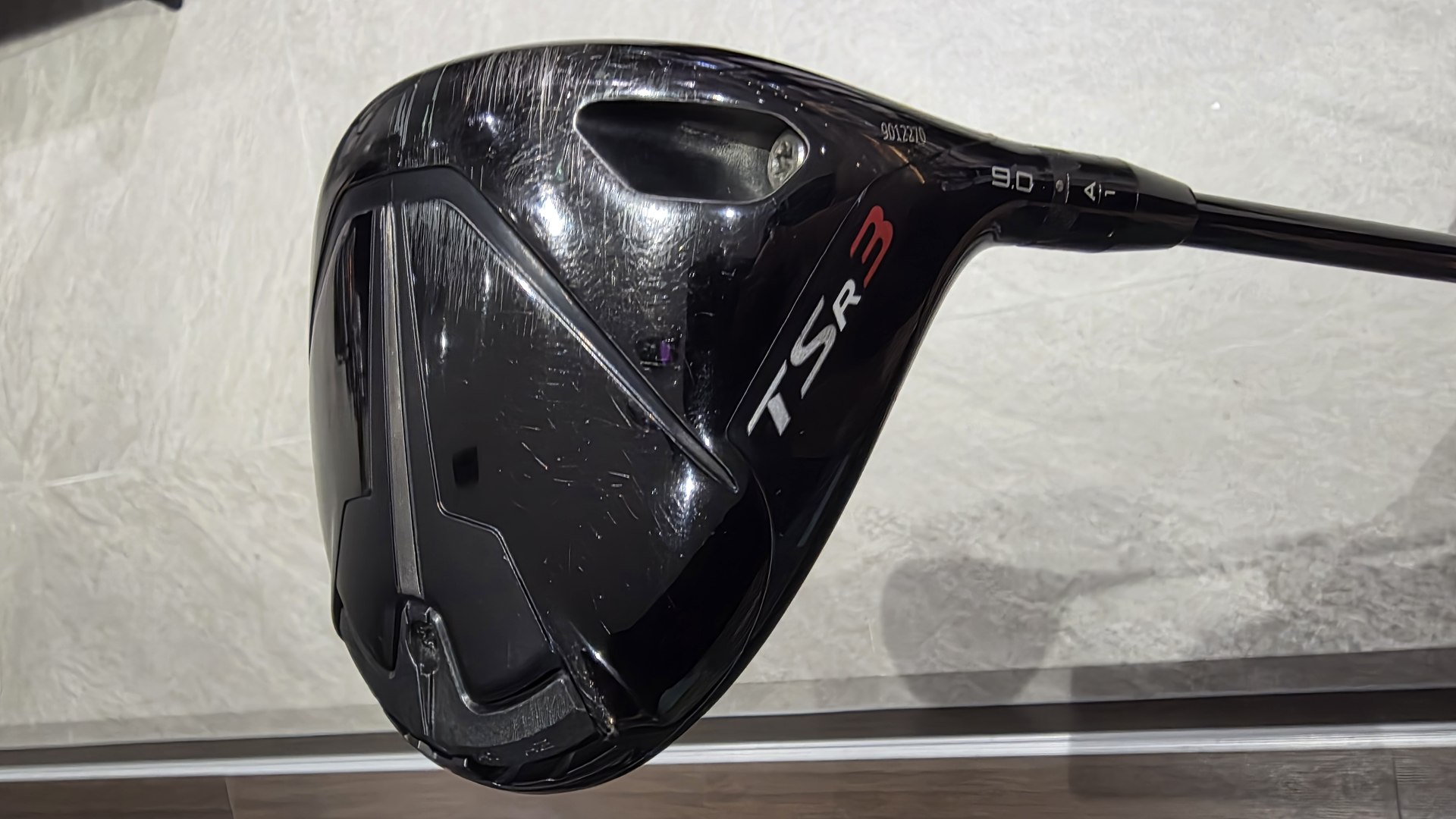 The author's Titleist TSR3 driver head resting on the floor.