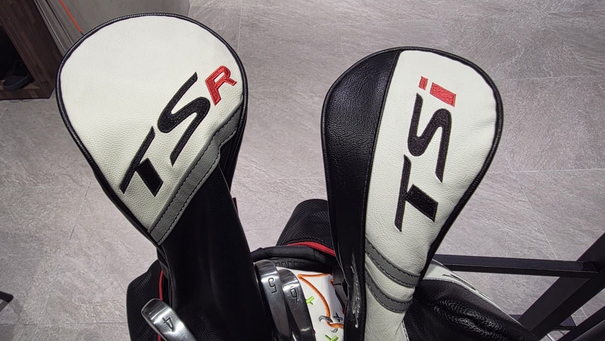 Two Titleist headcovers standing in the author's golf bag: a wide TSR driver cover on the left and a narrower TSi fairway cover on the right.