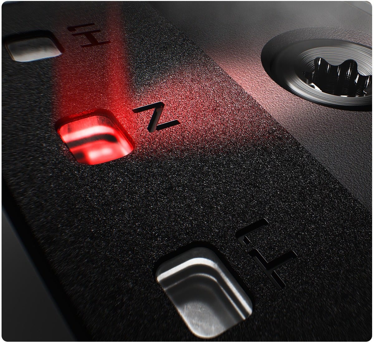 Close-up of the SureFit CG Track on a driver sole, showing lettered weight positions and a weight seated in one of them.