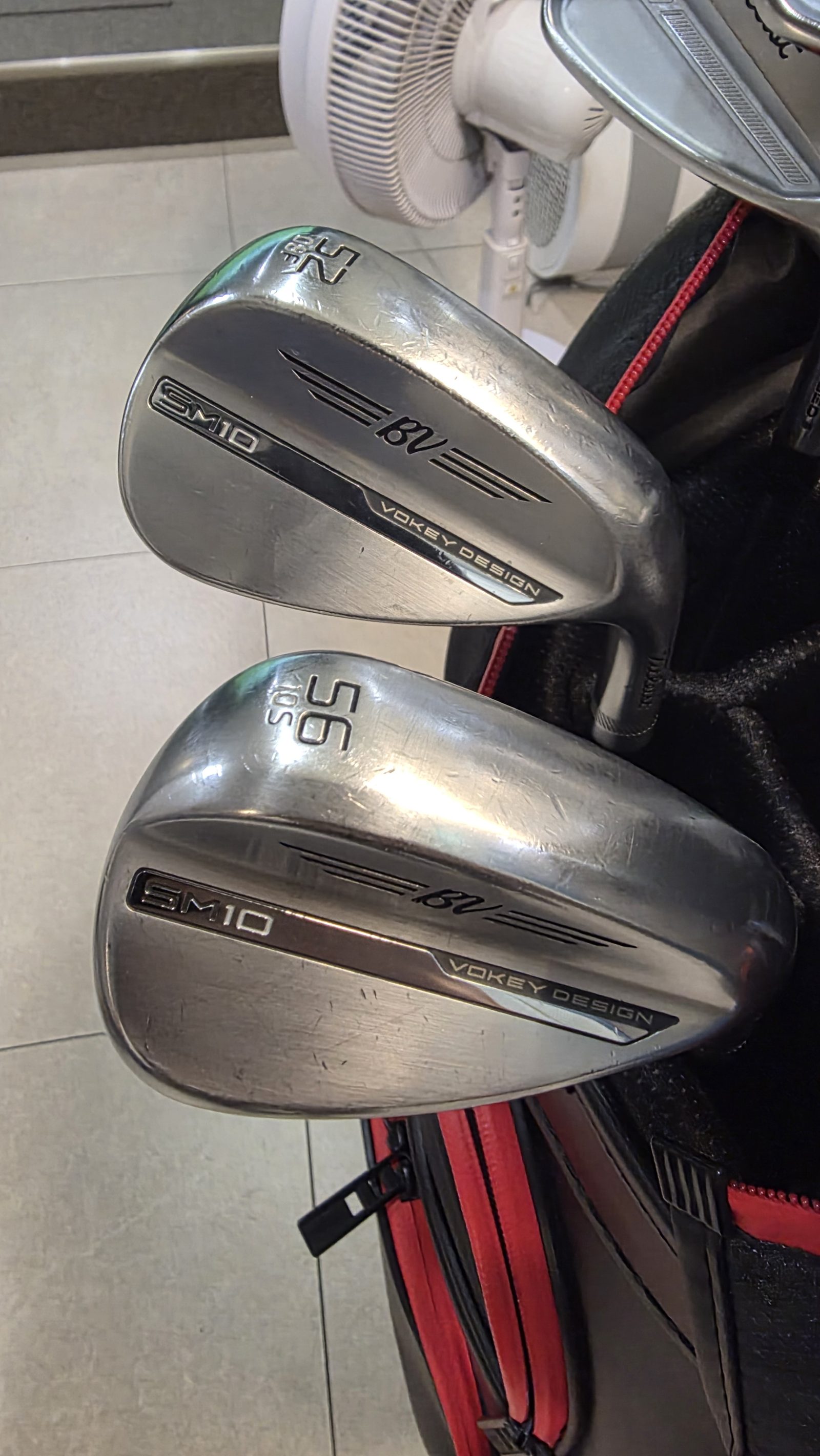 Vokey SM10 wedges, 52.08F and 56.10S, standing in a golf bag.