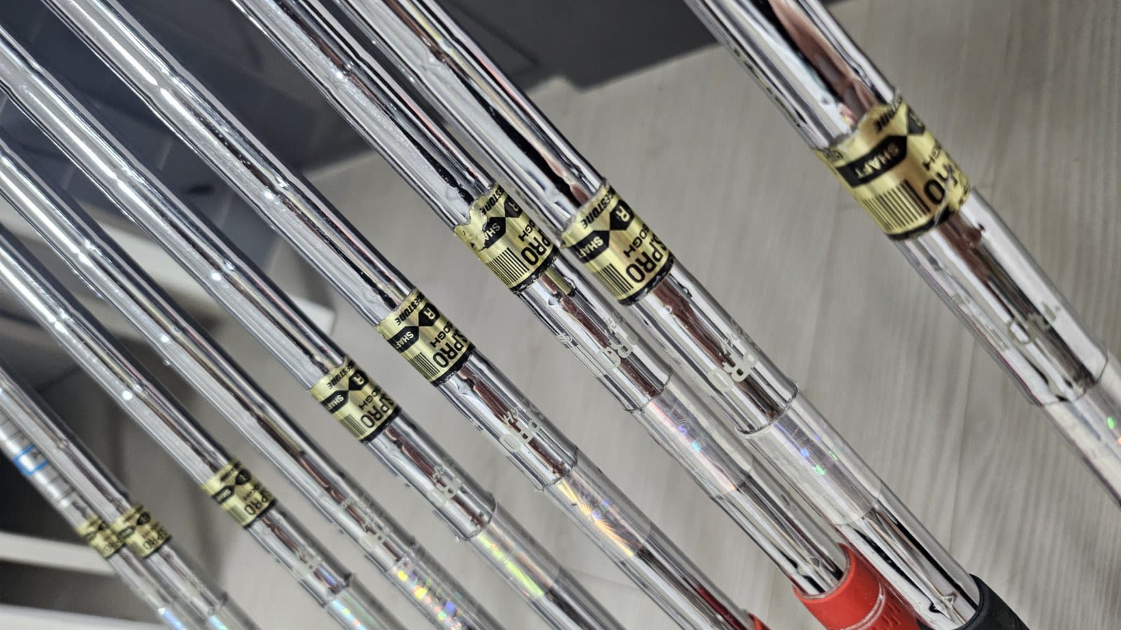 Close-up of shaft label bands reading N.S.PRO, a weight code, R, and Bridgestone on chrome steel shafts.