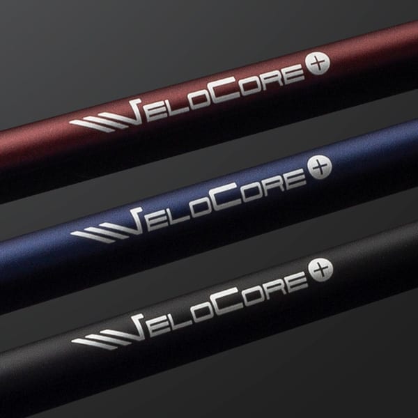 Close-up of red, blue, and black Fujikura shafts, each printed with the VeloCore+ logo near the tip end.